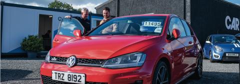 Dealer talking to customer on forecourt