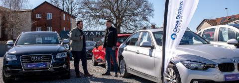 Customer and dealer talking on forecourt